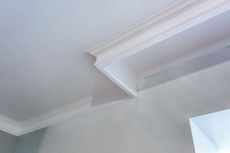 Detail of corner ceiling with intricate crown molding.