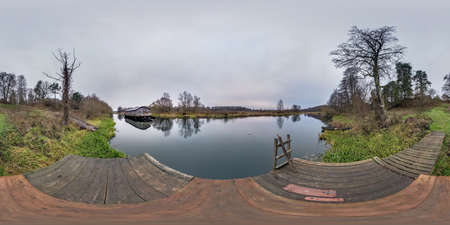 full spherical hdri panorama 360 degrees angle view on wooden pier in lake near old abandoned landing stage debarkader in equirectangular projection with zenith, ready VR AR virtual reality contentの写真素材