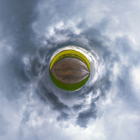 tiny planet in blue sky with sun and beautiful clouds. Transformation of spherical panorama 360 degrees. Spherical abstract aerial view. Curvature of space.の写真素材