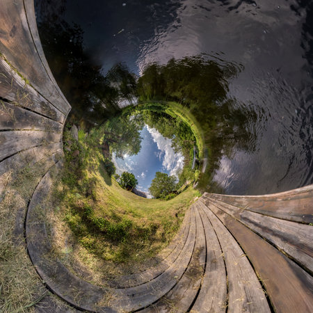Abstract inversion of little planet transformation of spherical panorama 360 degrees. Spherical abstract aerial view on wooden bridge near river. Curvature of space.の写真素材