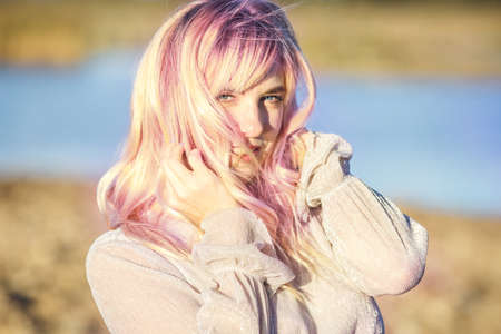 Outdoor close up portrait beautiful blonde girl with youth and skin care attractive looking at camera. Light keyの写真素材