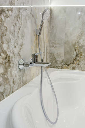 water tap sink with faucet in expensive bathroom with wall mount shower attachmentの写真素材