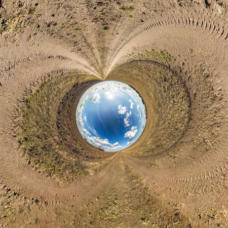 blue sky ball in middle of swirling asphalt road. Inversion of tiny planet transformation of spherical panorama 360 degrees. Spherical abstract view. Curvature of space.の写真素材