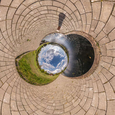 blue sky ball in middle of swirling asphalt road or field. Inversion of tiny planet transformation of spherical panorama 360 degrees. Spherical abstract view. Curvature of space.の写真素材