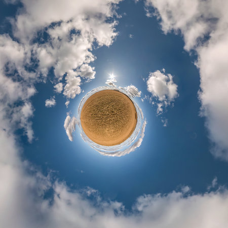 tiny planet in blue sky with beautiful clouds. Transformation of spherical panorama 360 degrees....