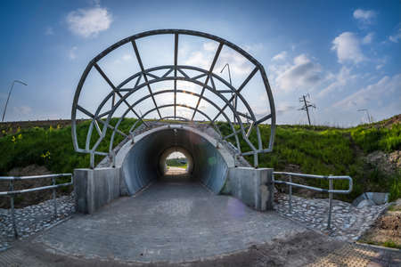 round tunnel footpath on blue sky backgroundの写真素材