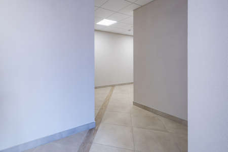 long white empty corridor in interior of entrance hall of modern apartments, office or clinic
