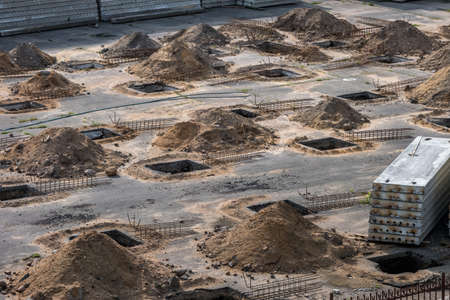rows of pits at a construction site. preparation of the site for the installation of piles. a pile...