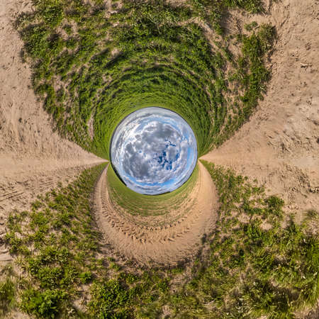 blue sky ball in middle of swirling road with grass. Inversion of tiny planet transformation of spherical panorama 360 degrees. Curvature of space.の写真素材