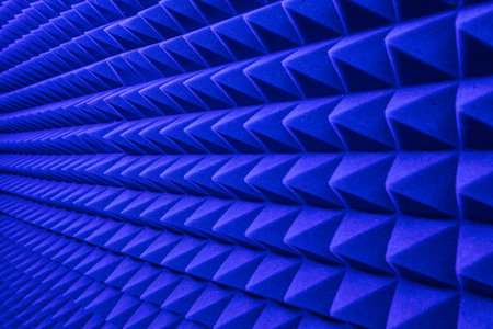 rows of acoustic music soundproof foam pyramid panel with blue lighting.の写真素材