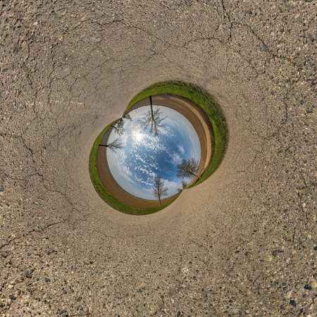 blue sphere little planet inside gravel road background.