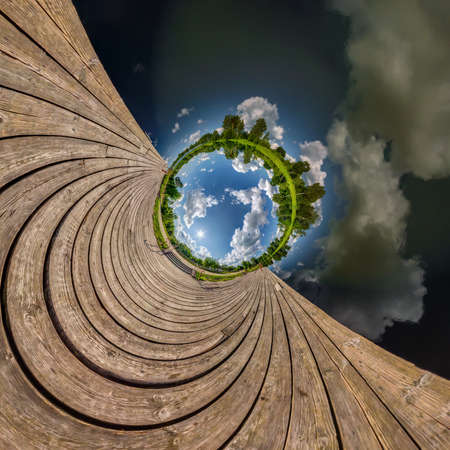 blue sphere little planet inside transformation of wooden pier and lake.