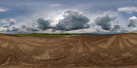 360 seamless hdri panorama view among plowed fields with white clouds in blue sky before storm in equirectangular spherical projection, ready AR VR virtual reality contentの写真素材