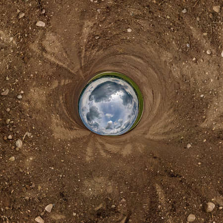 blue sphere little planet inside gravel road or field background.の写真素材