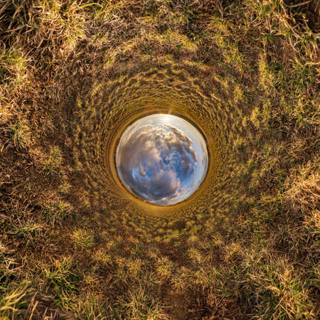 blue sphere little planet inside gravel road or field background.の写真素材