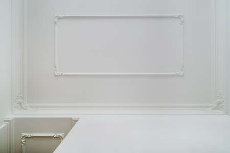 Detail of corner and ceiling cornice with intricate crown molding.
