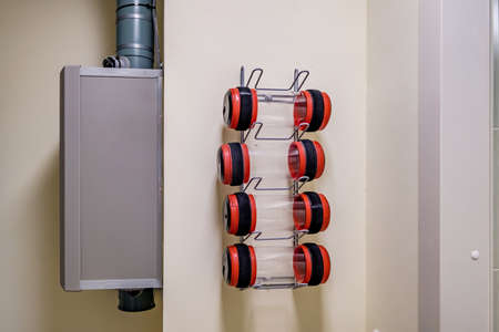 rows of empty pneumatic tubes of transfer system station in modern clinic, designed for fast...