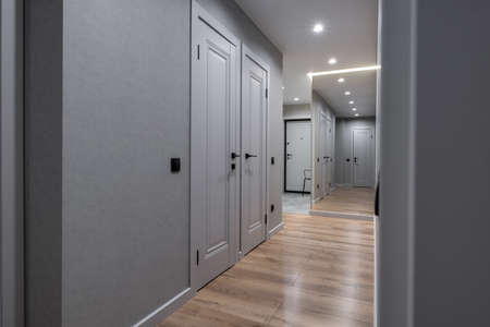 long empty corridor in interior of entrance hall of modern apartments, office or clinic