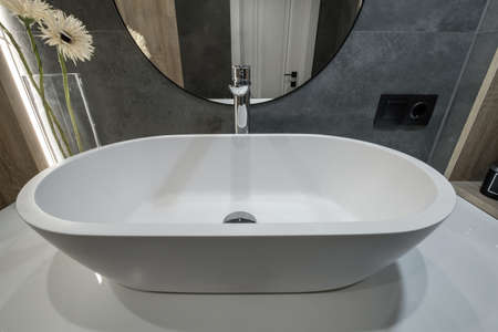 metal water tap with sink and faucet to turn on and regulate cold or hot water in expensive bathroom.の写真素材