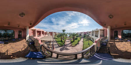 DAHAB, EGYPT - DECEMBER 2021: full seamless spherical hdr 360 panorama view on second floor of balcony or terrace overlooking palm trees in equirectangular projection, for VR AR virtual realityのeditorial素材