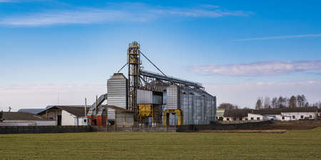 agro silos granary elevator. Silos on agro-processing manufacturing plant for processing drying cleaning and storage of agricultural products, flour, cereals and grain.の写真素材