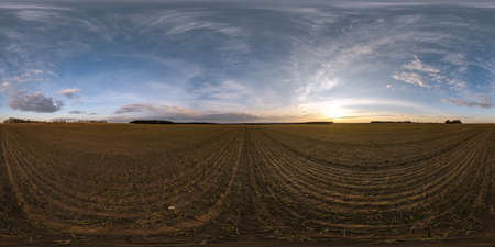evening hdr panorama 360 view among farming fields with sunset clouds in equirectangular spherical...
