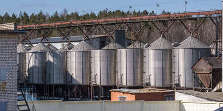 panorama view on agro silos granary elevator on agro-processing manufacturing plant for processing...