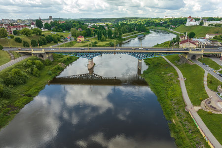 aerial view from great height on wide river and huge bridge of old cityの写真素材