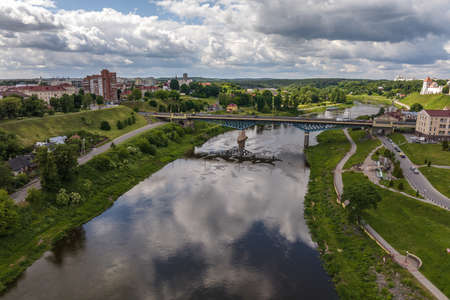 aerial view from great height on wide river and huge bridge of old cityの写真素材