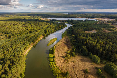 panoramic view from a high altitude of a meandering river in the forestの写真素材