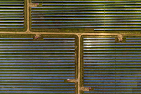 aerial view on huge farm field of rows of solar panels. Renewable solar energy.