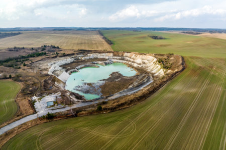 ariel top view of an old flooded lime quarry with turquoise water