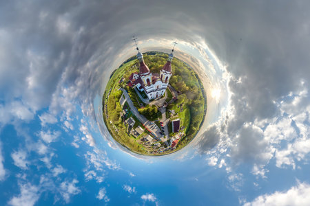 little planet transformation of spherical panorama 360 degrees overlooking church in center of globe...