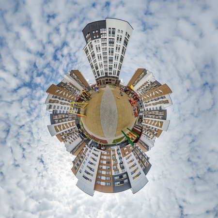 tiny planet in blue sky with clouds in city center near modern skyscrapers or office buildings. Transformation of spherical 360 panorama in abstract aerial view.の写真素材