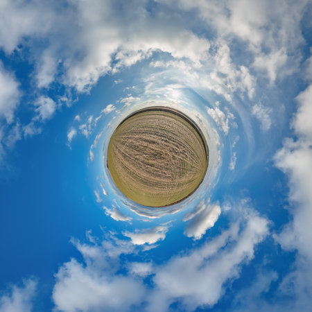 simple tiny planet without buildings in blue sky with beautiful clouds. Transformation of spherical panorama 360 degrees. Spherical abstract aerial view. Curvature of space.の写真素材