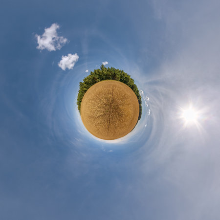 simple little tiny planet without buildings in blue sky with beautiful clouds. Transformation of spherical panorama 360 degrees. Spherical abstract aerial view. Curvature of space.の写真素材