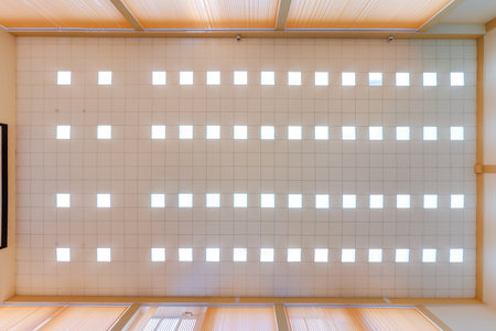 cassette stretched or suspended ceiling with square halogen spots lamps and drywall construction in...