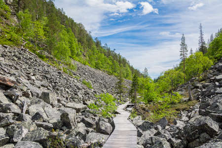View of The Pyha-Luosto National Park in summer, wooden walkway and rocks, Lapland, Finland