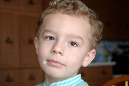 Milk on boy's chinの写真素材