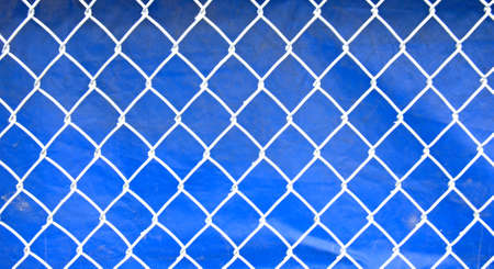 White fence against blue backgroundの写真素材