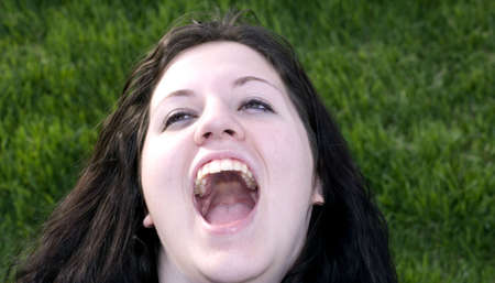 Teenage girl with big open mouth while outside