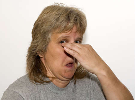 Nature woman holding nose due to stinkyの写真素材