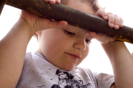 Young boy looking down holding barの写真素材