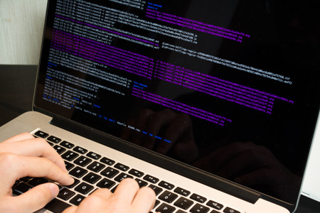 Asian engineer writing a programme on a computer