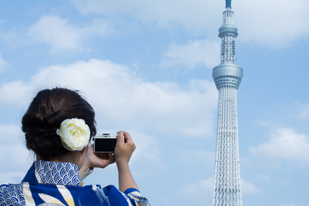 A woman wearing Kimono is taking pictures at Asakusaのeditorial素材