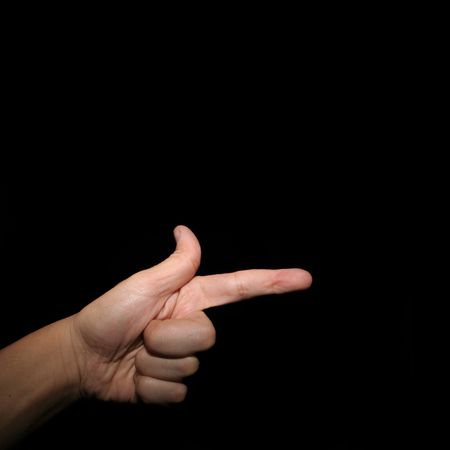 A hand pointing with a black backgroundの写真素材