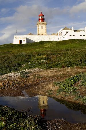 a lighthouse and is reflex in cape roca in portugalの写真素材