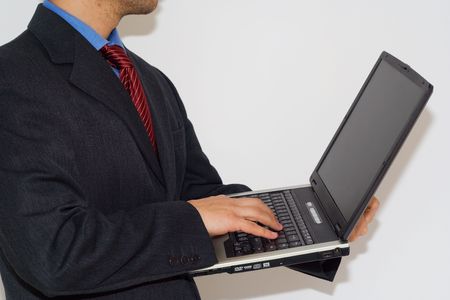 A business man working standup with a laptop の写真素材