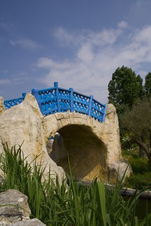 A small blue bridge with a cloudy skyの写真素材