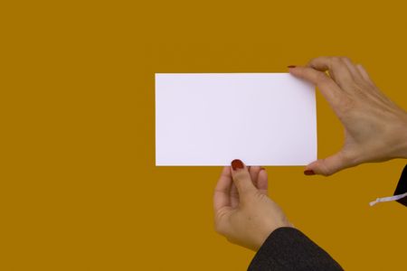 businesswoman showing a blank card with a colored background (focus on the card)